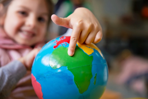 girl-pointing-at-globe